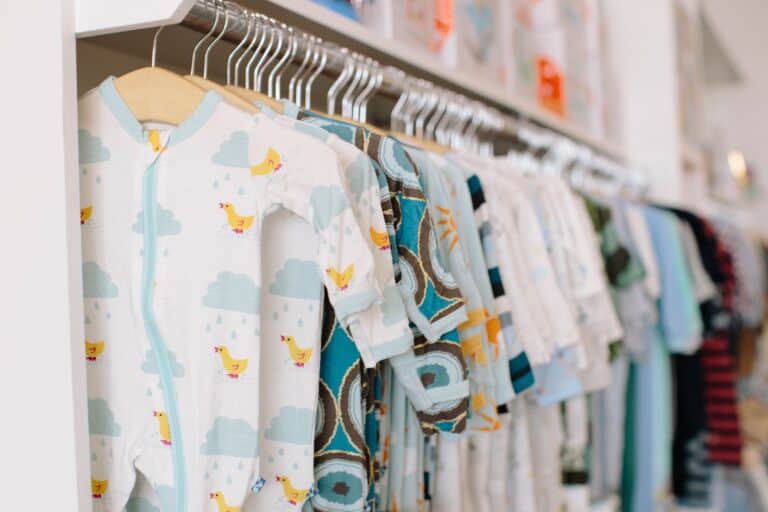Organic baby pajamas hanging in closet.